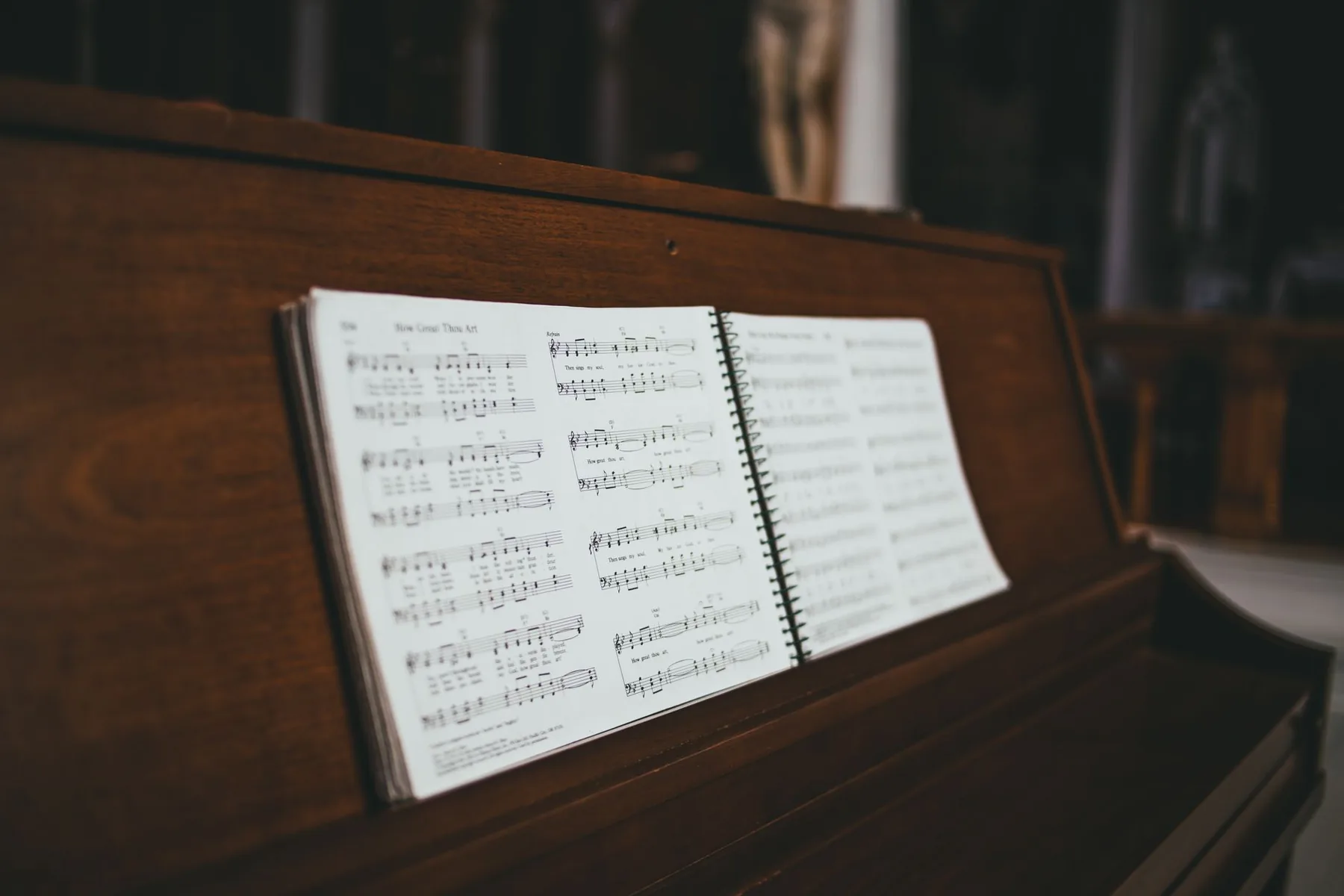 Open sheet music on an upright piano Open sheet music on an upright piano
