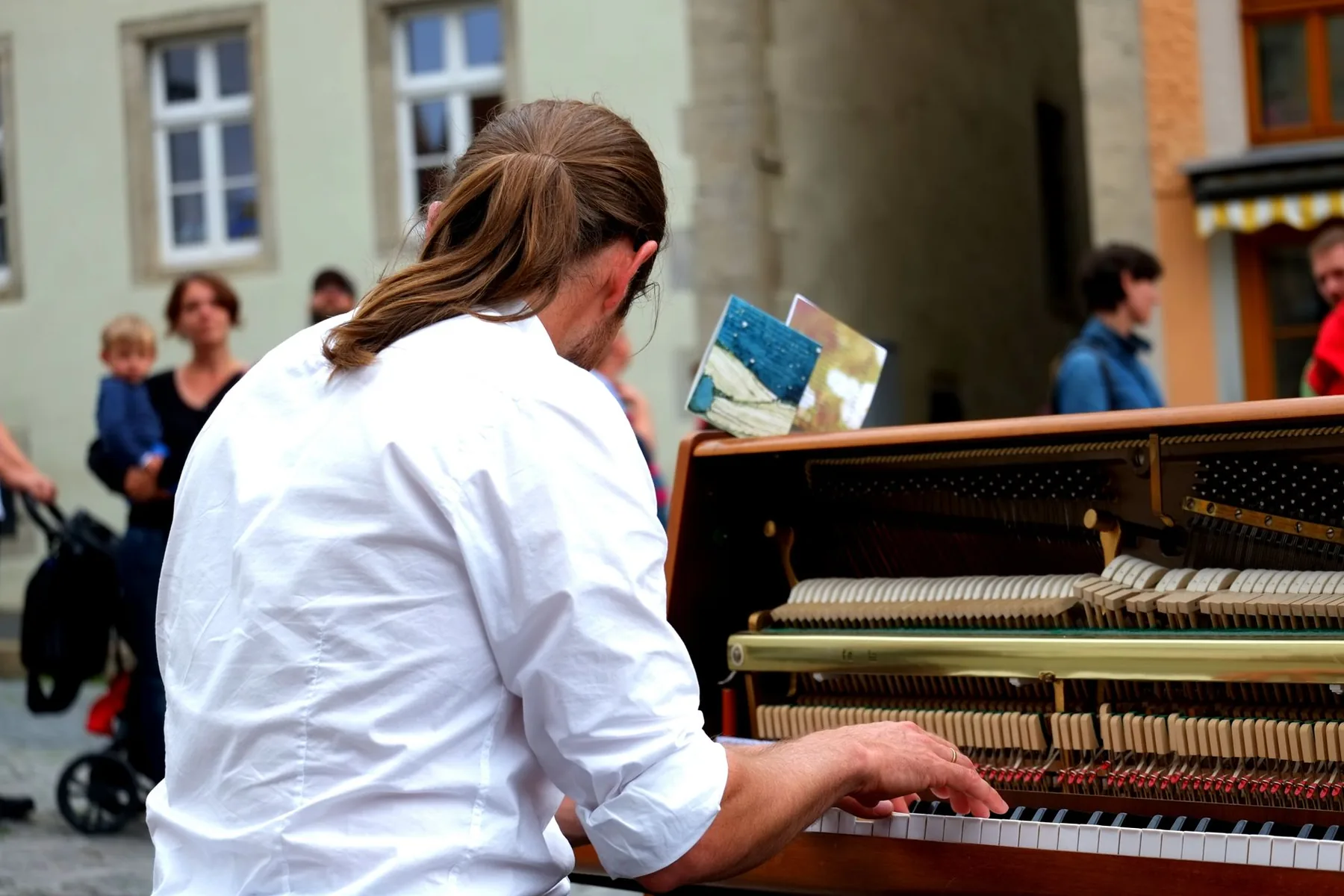 Pianist playing an upright piano