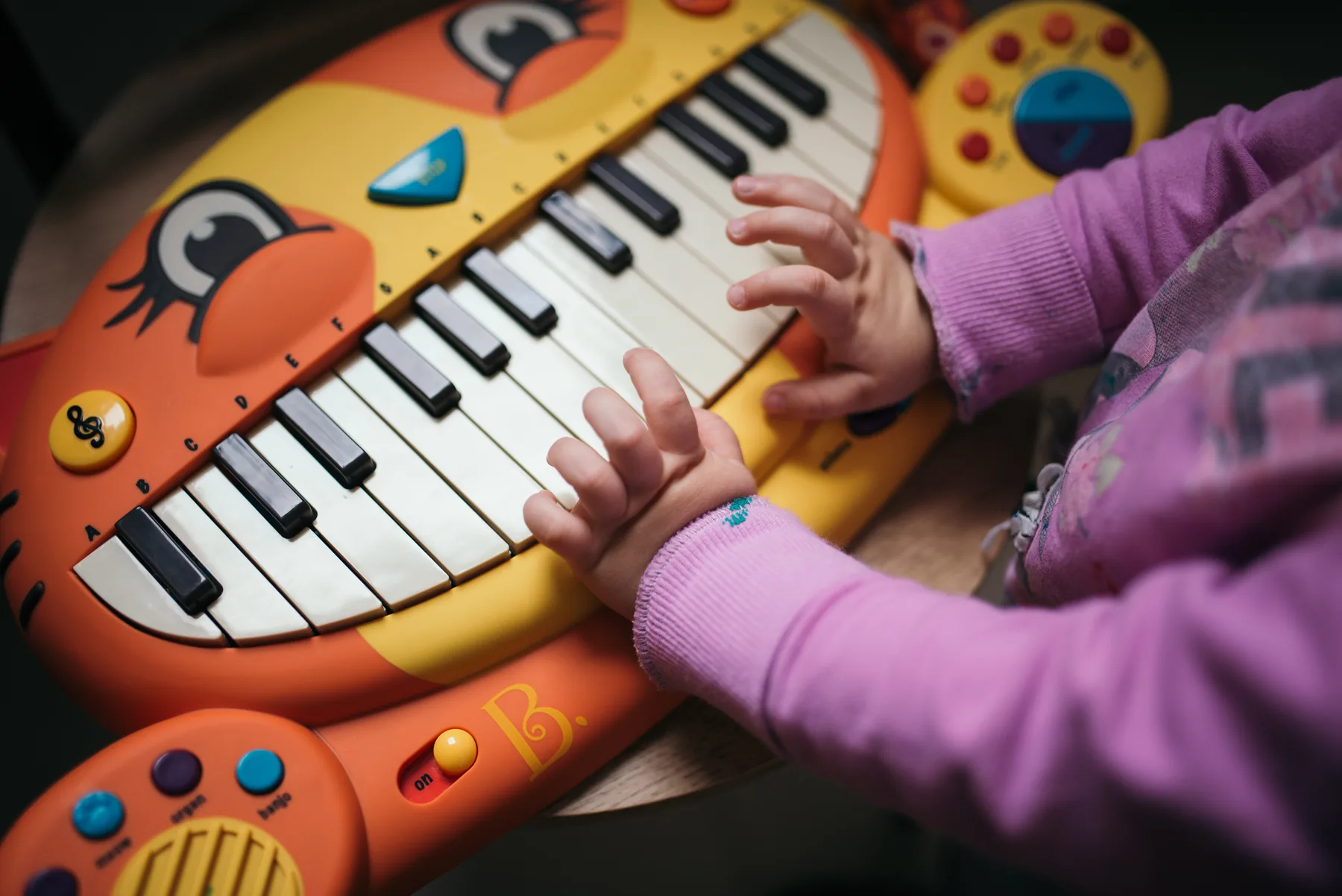 Child discovering an educational music keyboard Child discovering an educational music keyboard