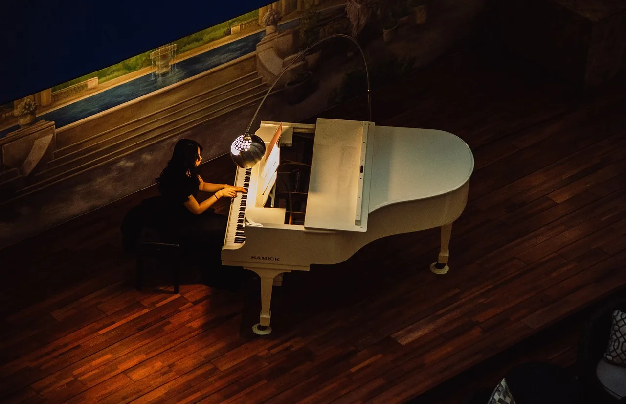 Pianist playing a grand piano Pianist playing a grand piano