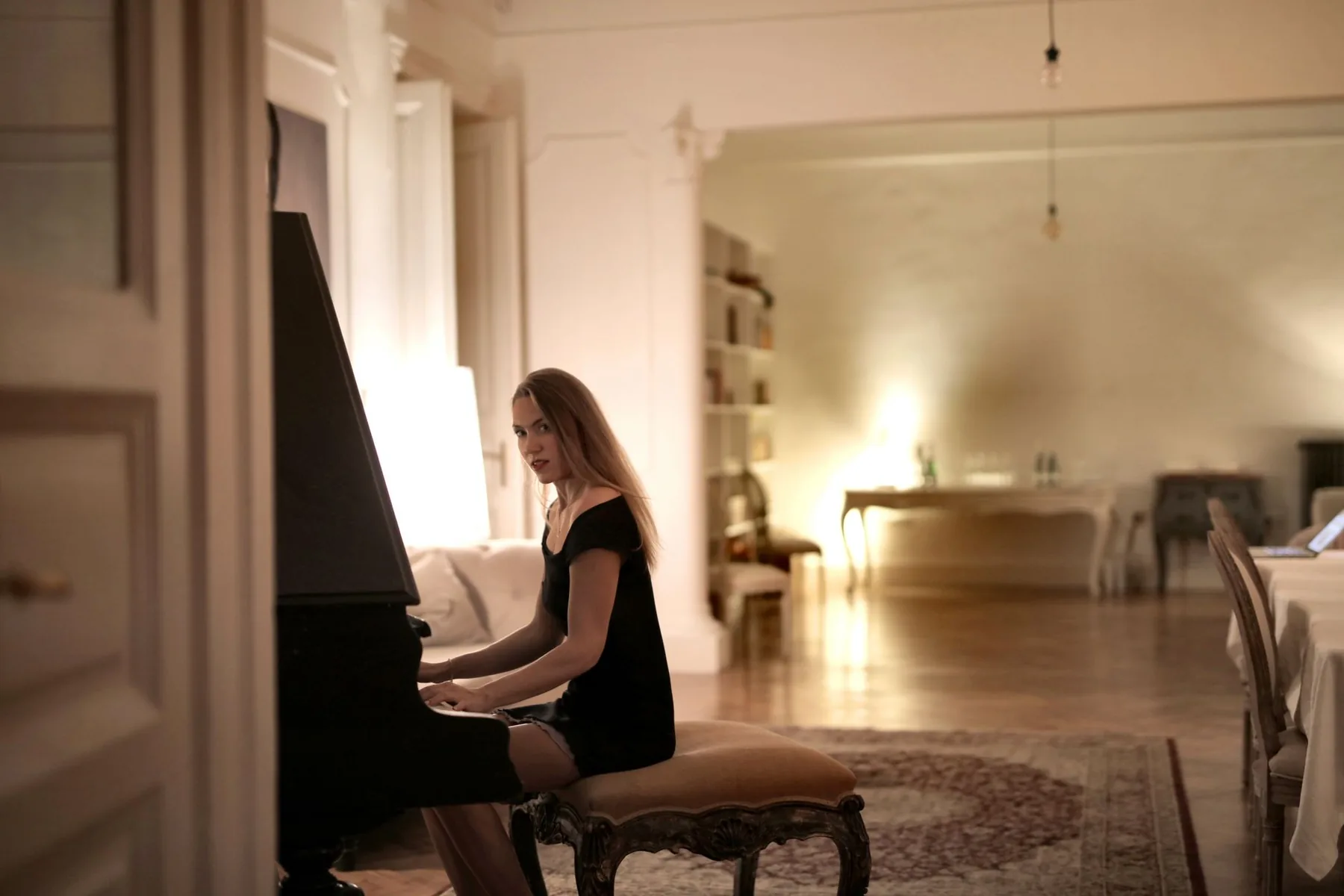Pianist playing in an elegant living room
