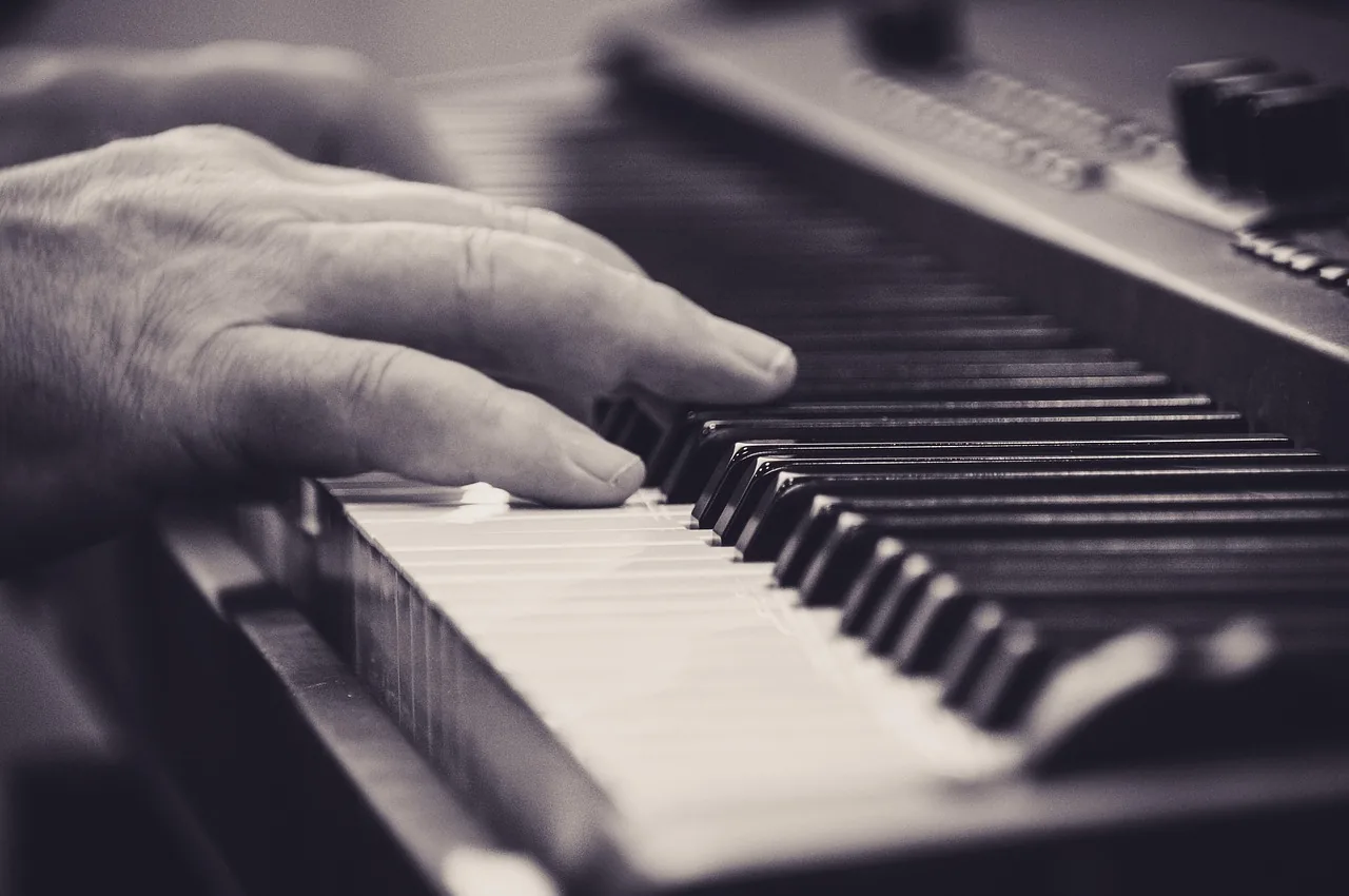 Fingers playing on a piano keyboard Fingers playing on a piano keyboard