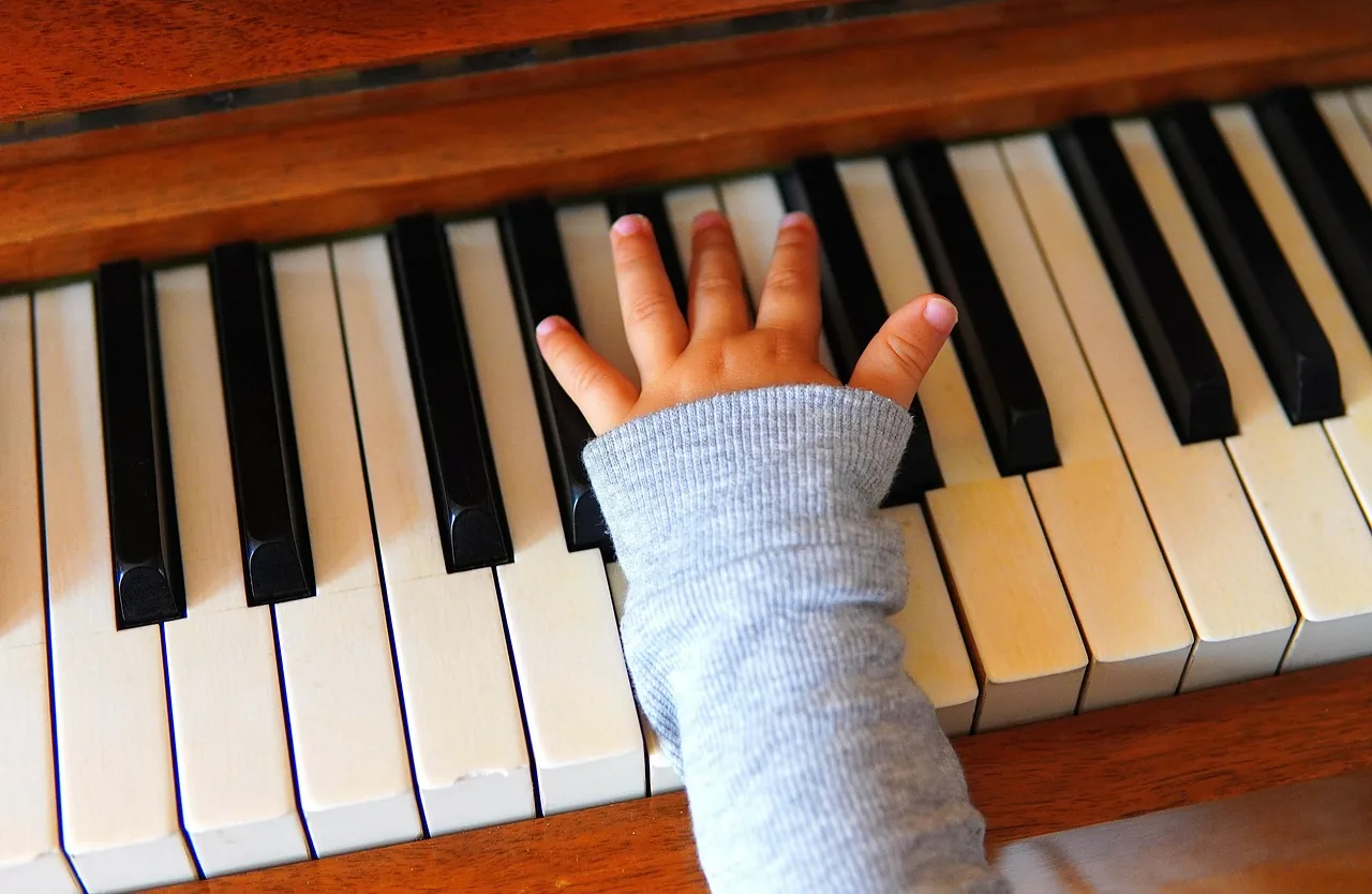 Child’s hand on a piano Child’s hand on a piano