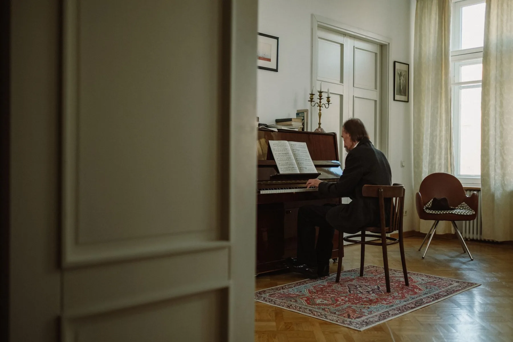 Pianist performing a work indoors Pianist performing a work indoors