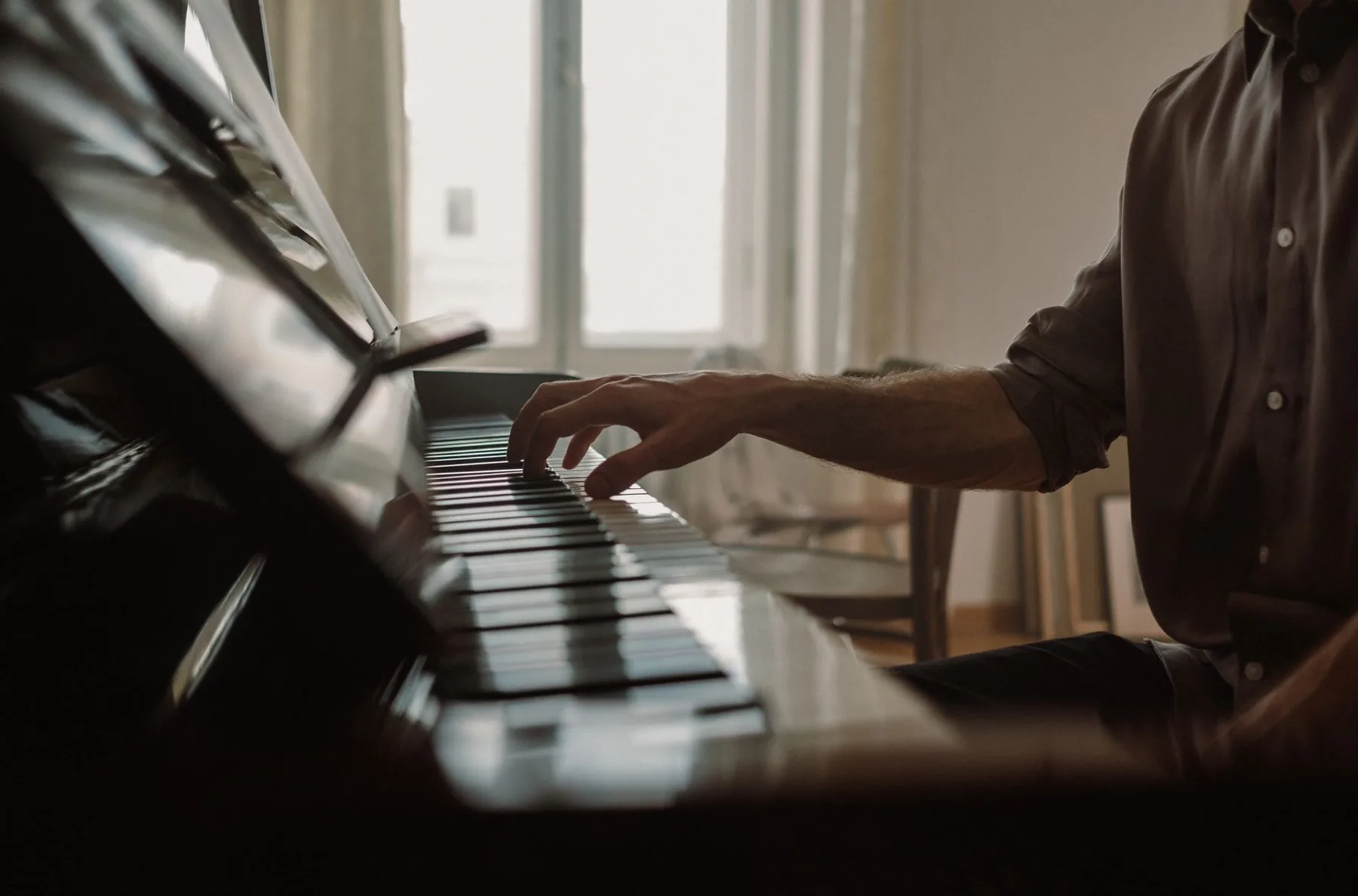 Pianist playing an upright piano Pianist playing an upright piano