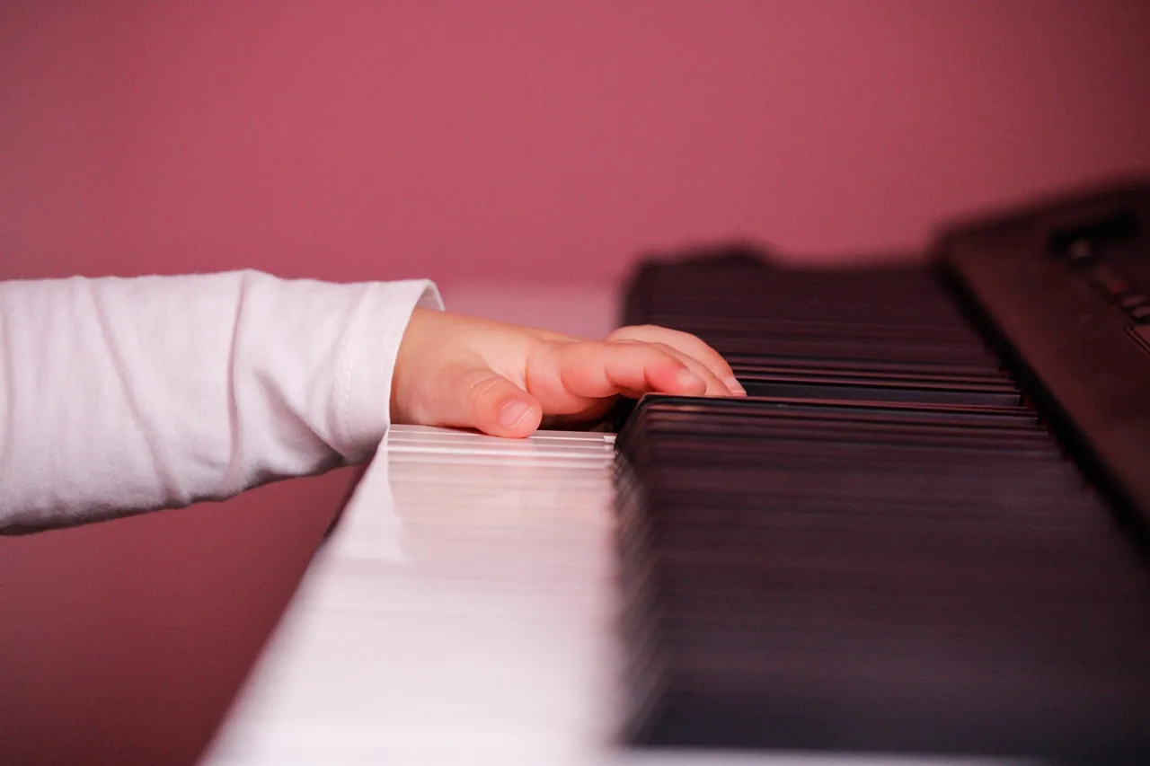 Hand playing a piano Hand playing a piano