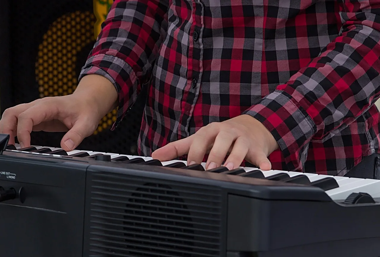 Hands playing a digital keyboard Hands playing a digital keyboard