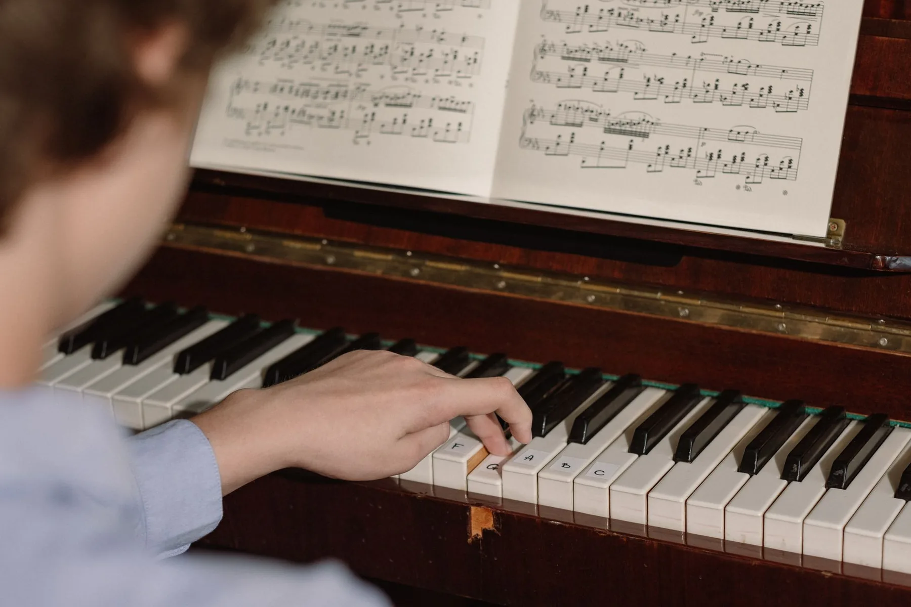 Pianist playing an upright piano Pianist playing an upright piano