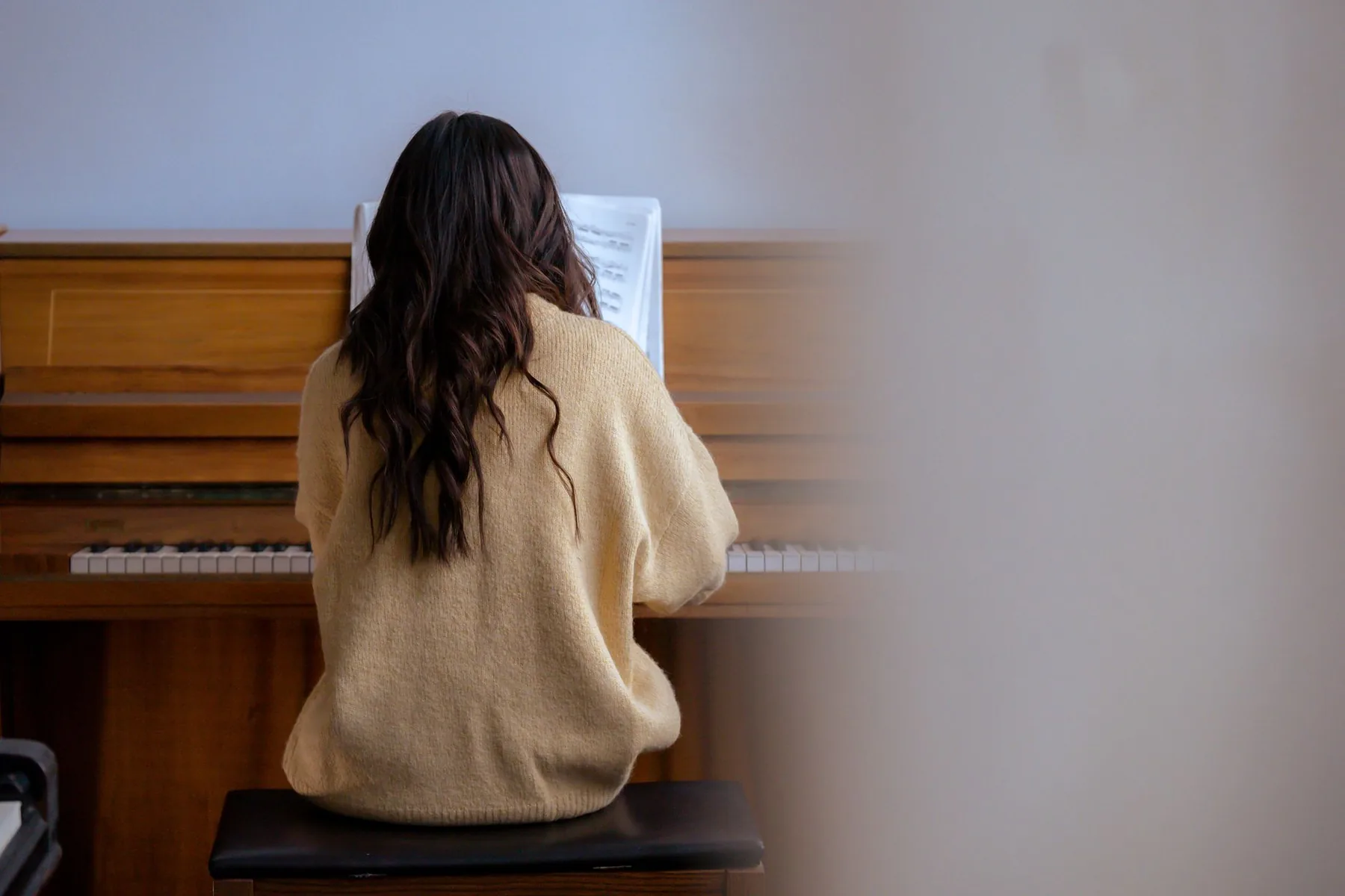 Pianist seated on a piano bench Pianist seated on a piano bench