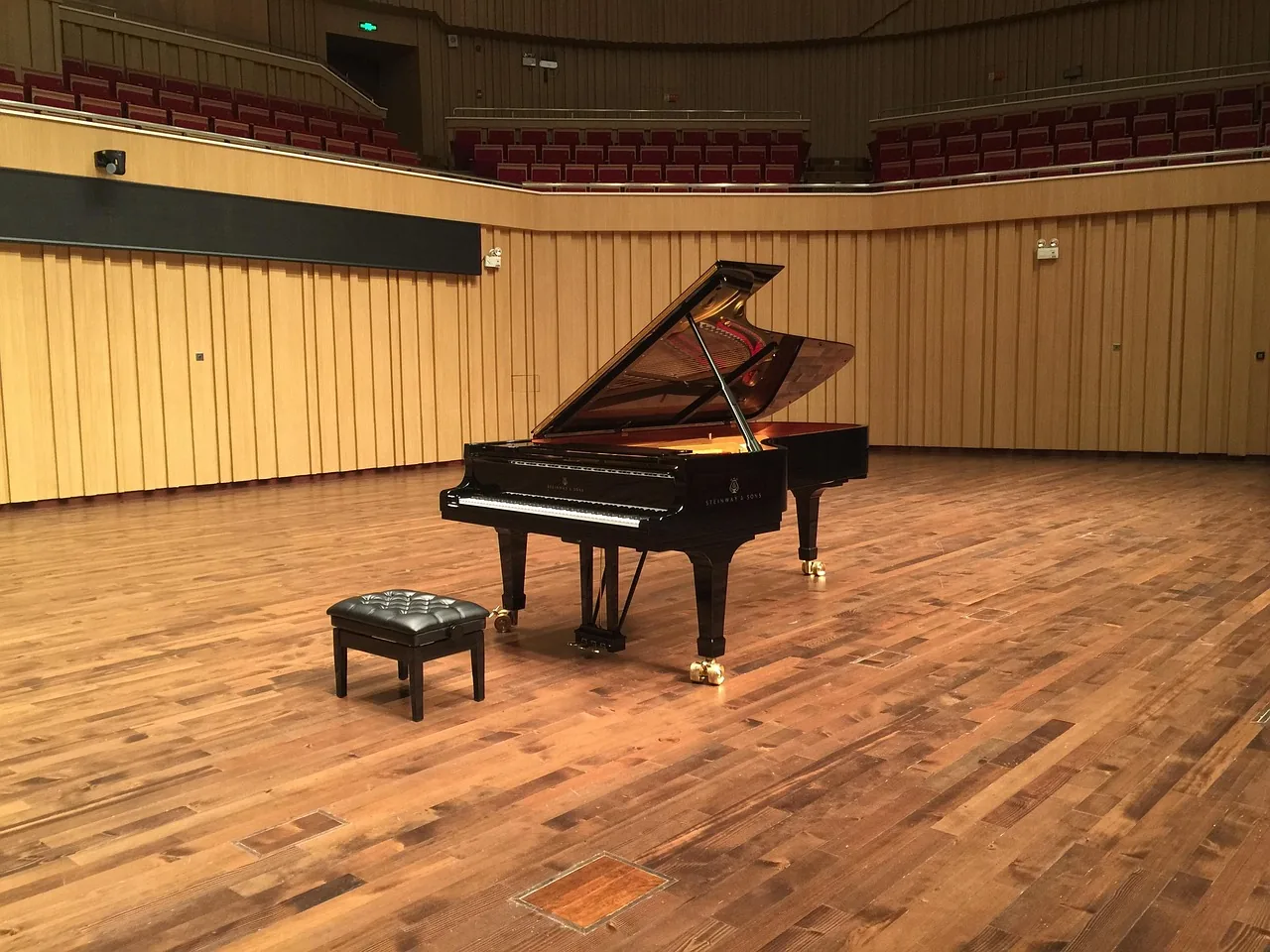 Adjustable bench in front of a grand piano Adjustable bench in front of a grand piano