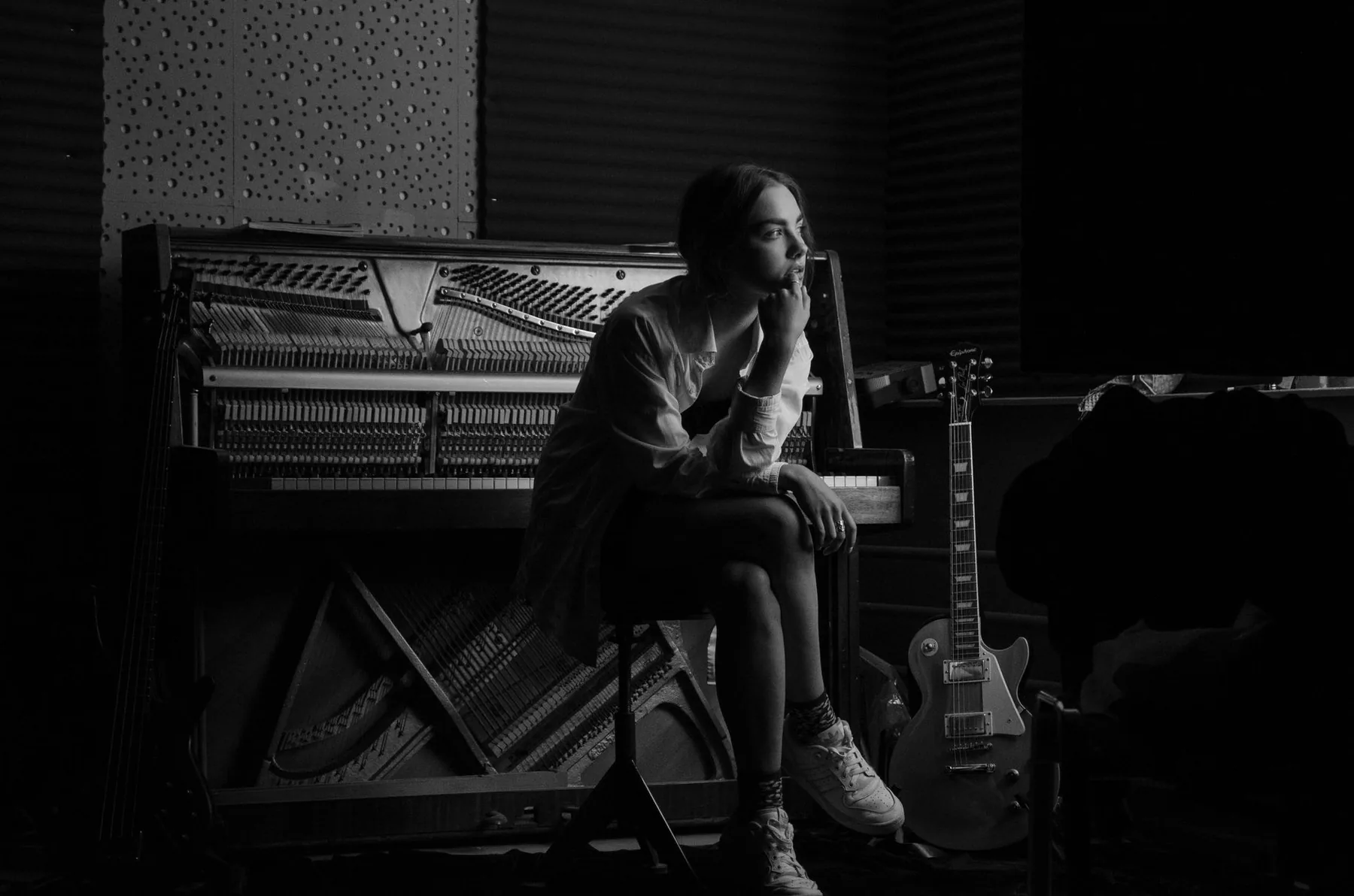 Female musician seated at an upright piano Female musician seated at an upright piano