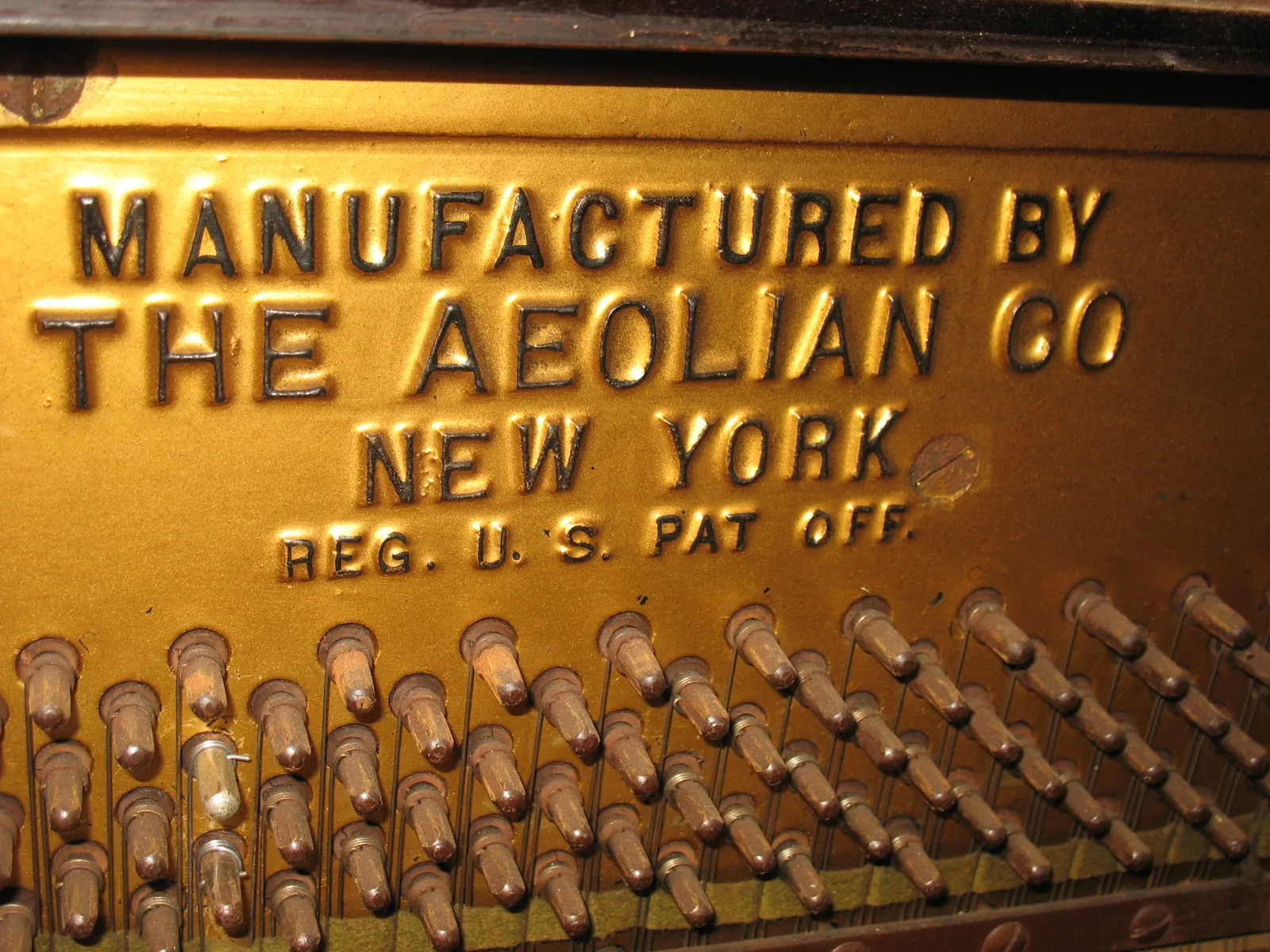 Manufacturer’s plate on an old piano Manufacturer’s plate on an old piano