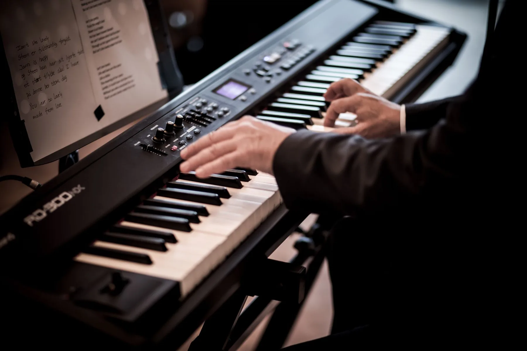Musician playing two digital pianos Musician playing two digital pianos