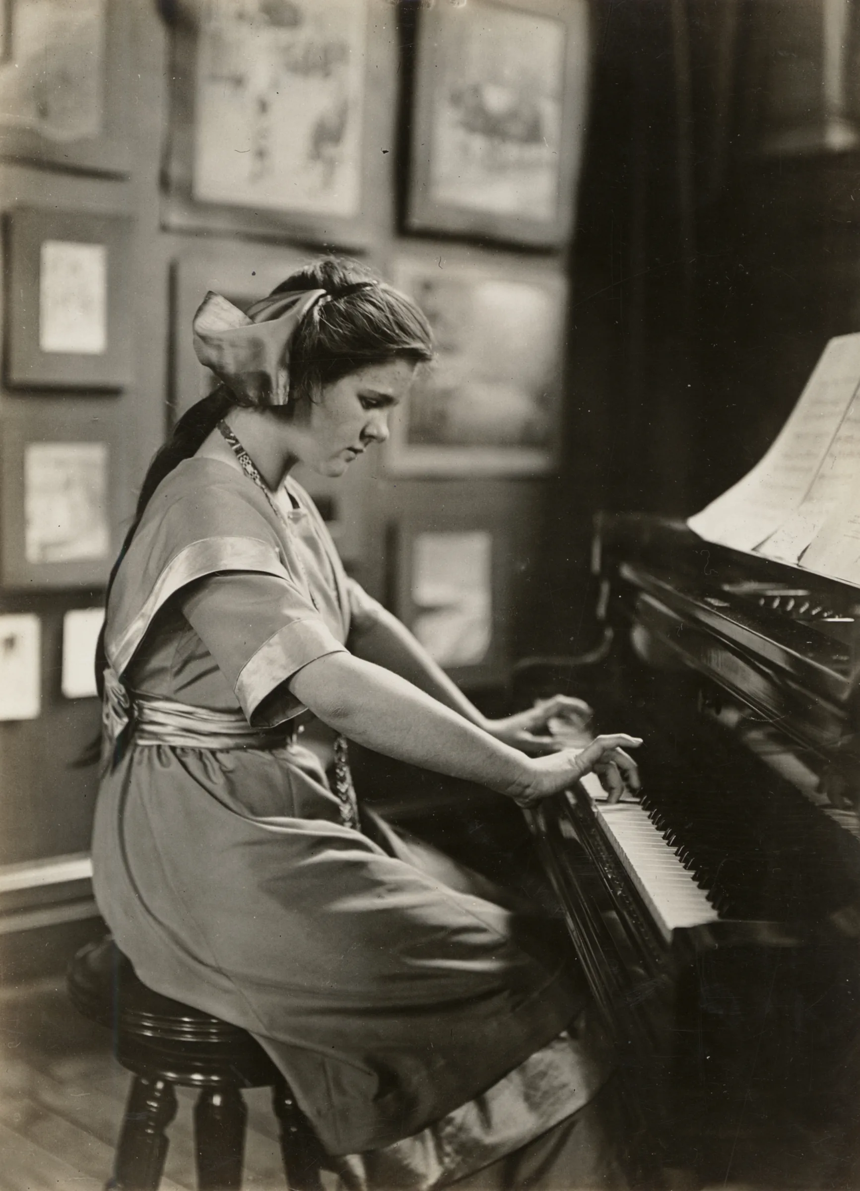 Female musician playing an acoustic piano Female musician playing an acoustic piano