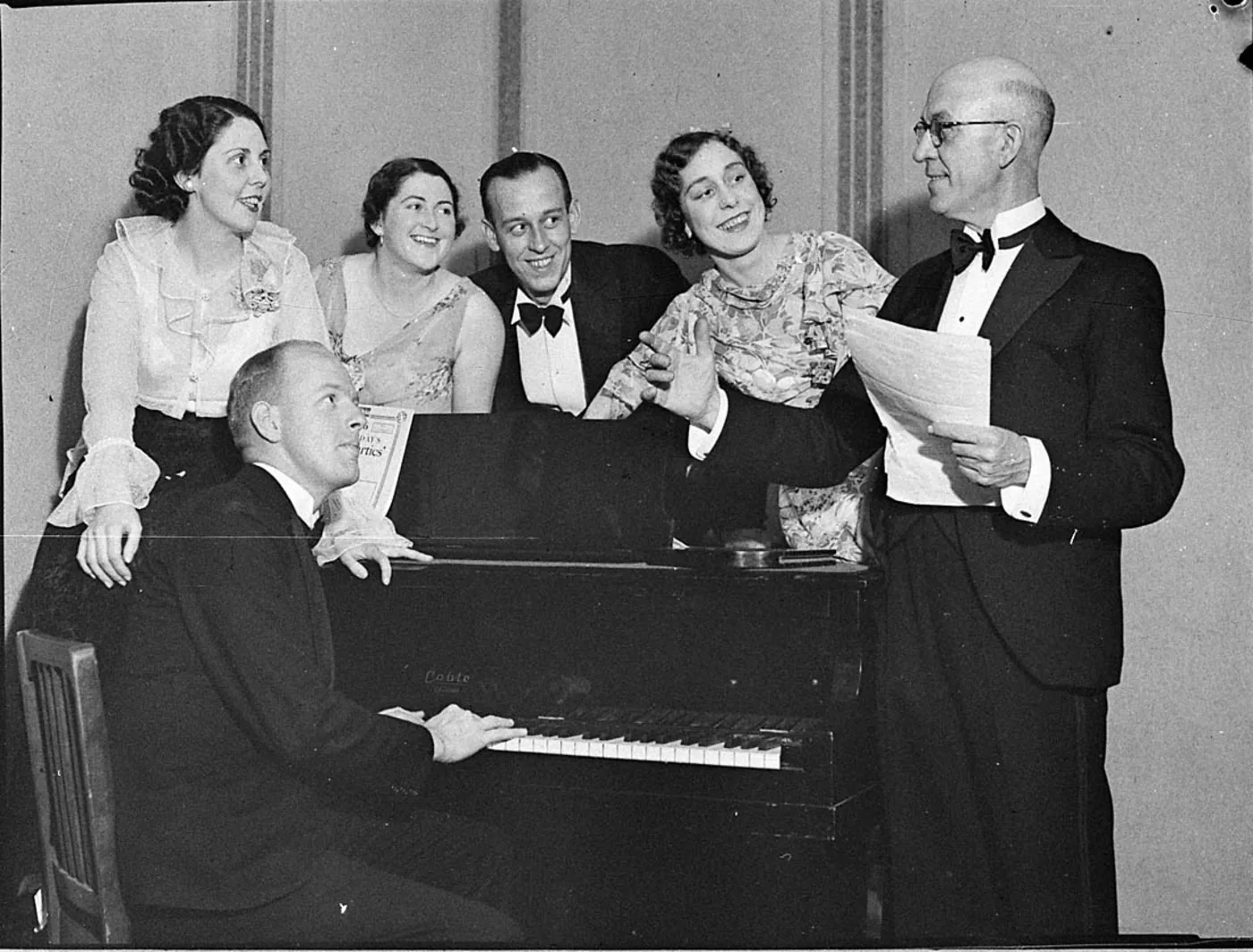 Group singing around a piano