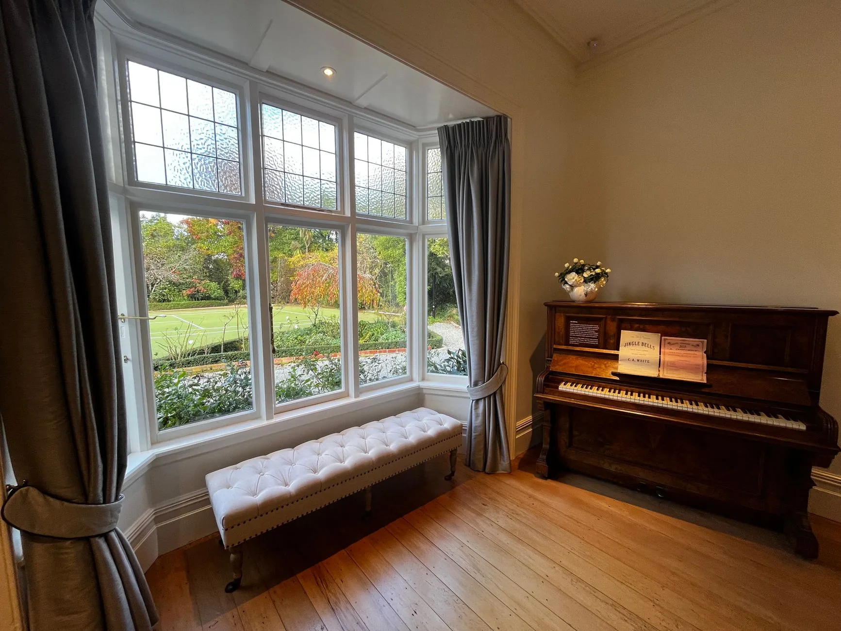 Upright piano in a bright living room Upright piano in a bright living room