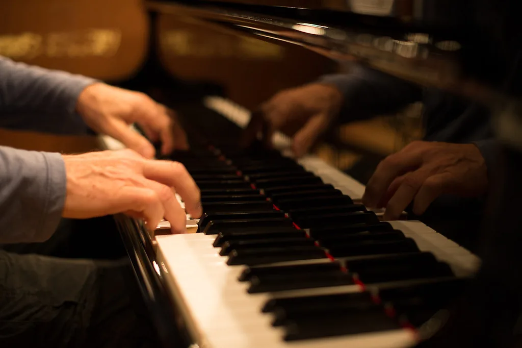 Hands playing a digital piano