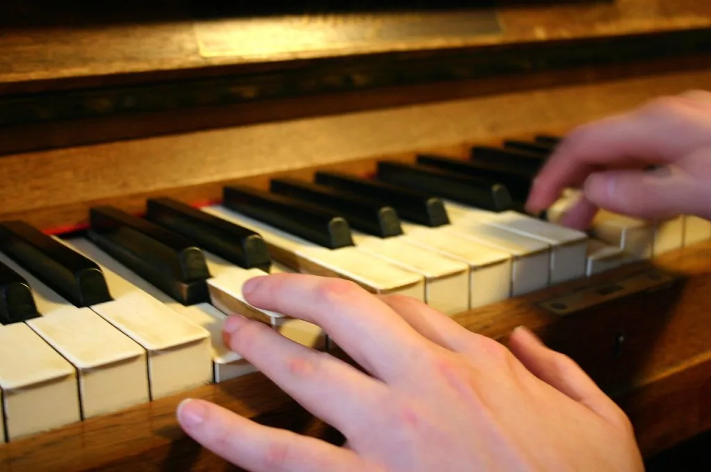 Hands playing an old piano