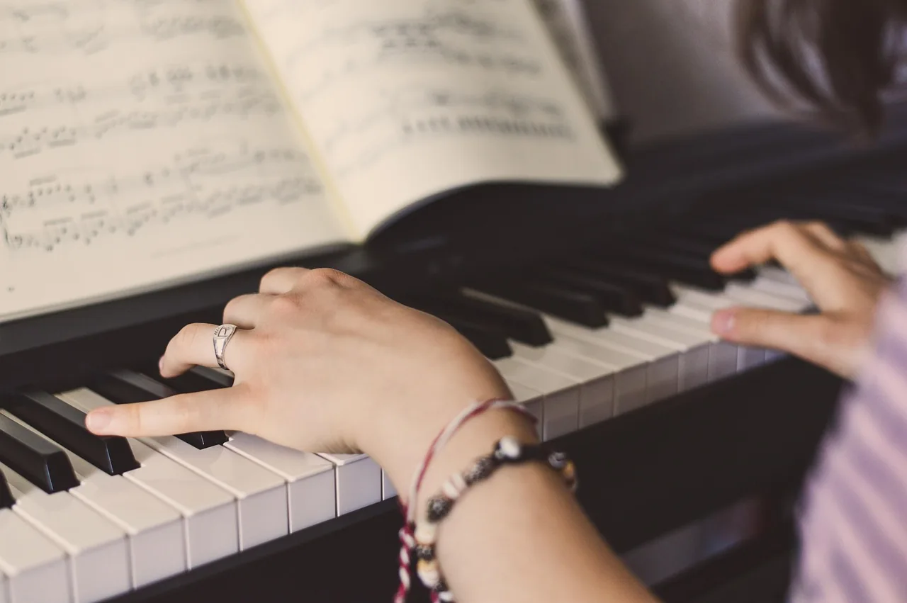 Musician playing a digital piano Musician playing a digital piano