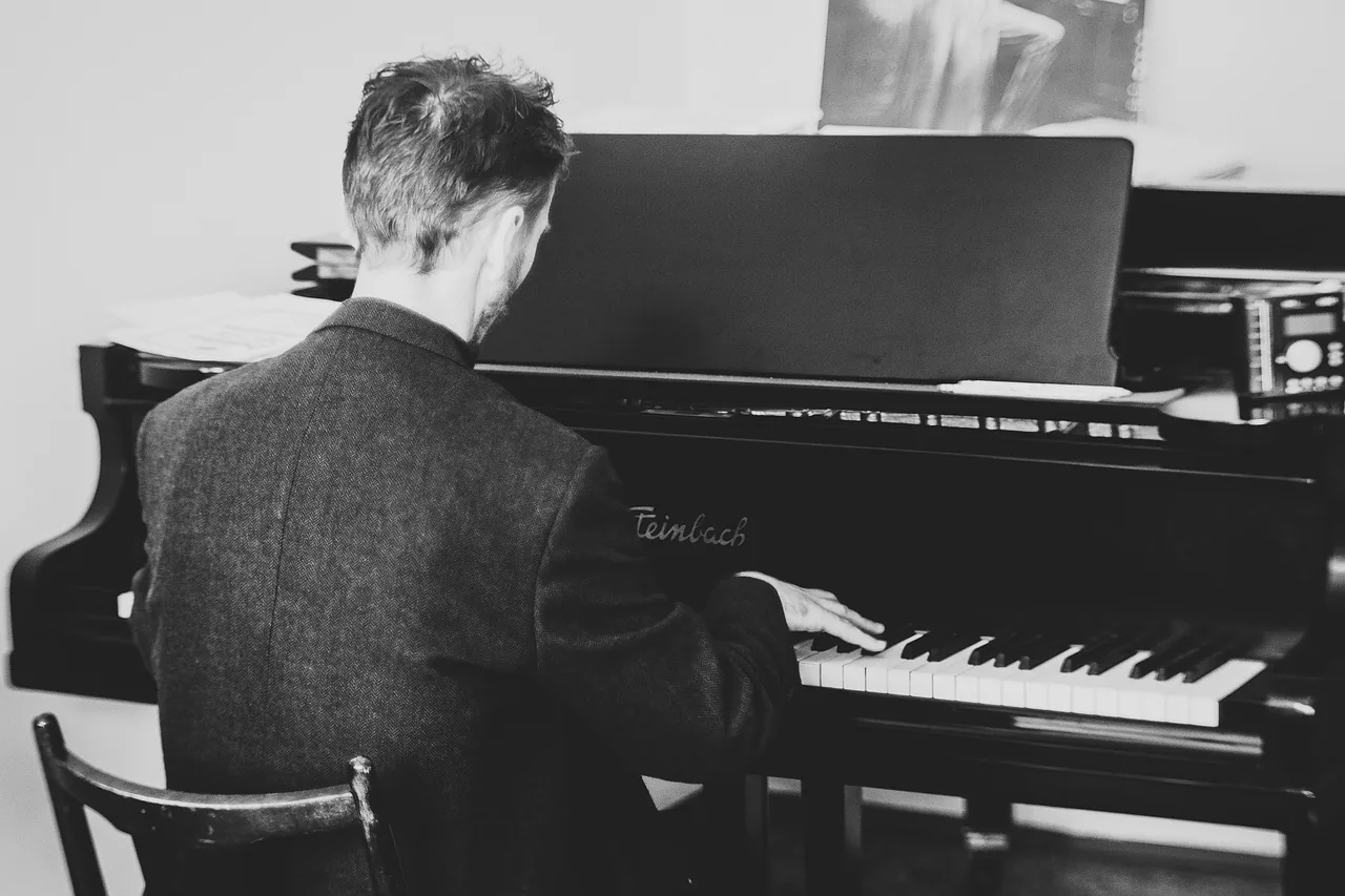 Musician playing piano in a studio Musician playing piano in a studio