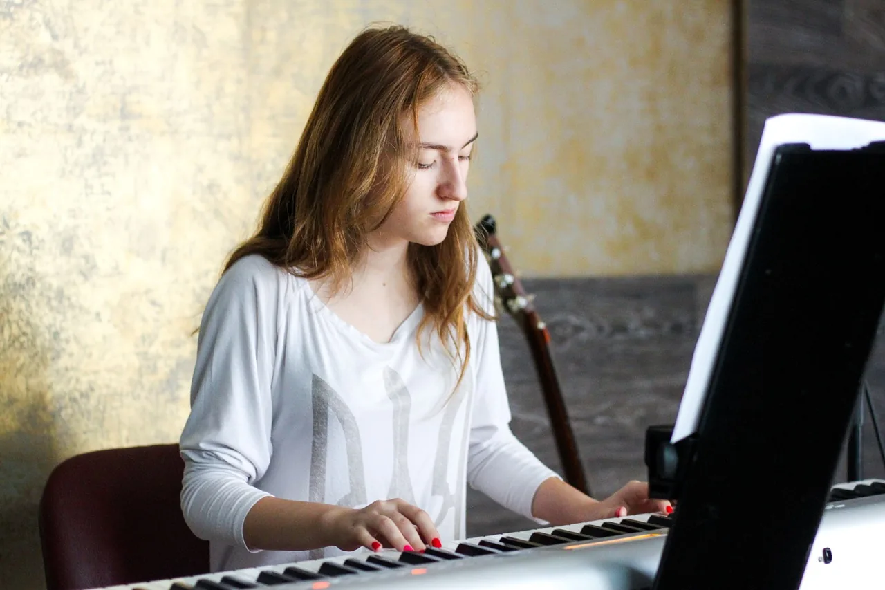Musician playing a portable digital piano Musician playing a portable digital piano