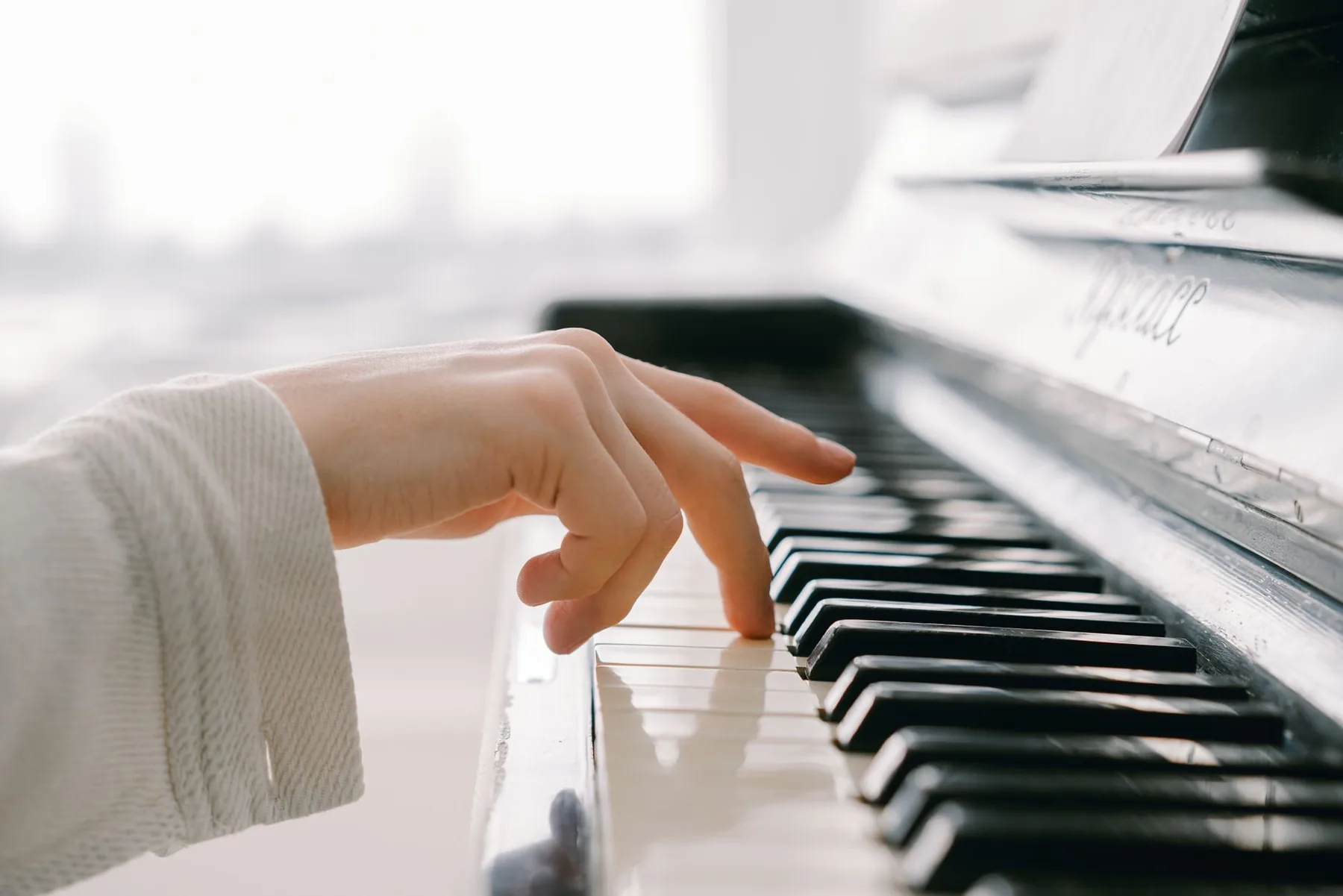 Hand playing piano keys Hand playing piano keys