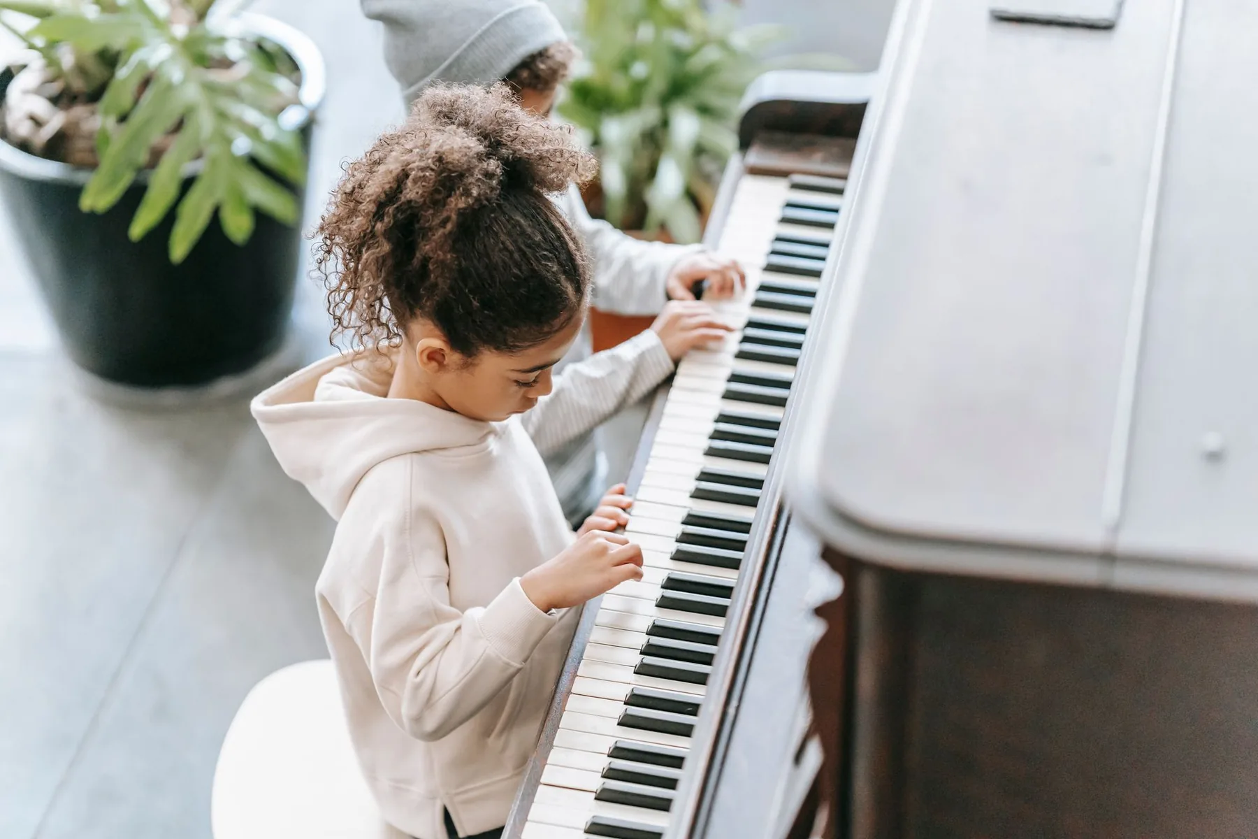 Children discovering an upright piano Children discovering an upright piano