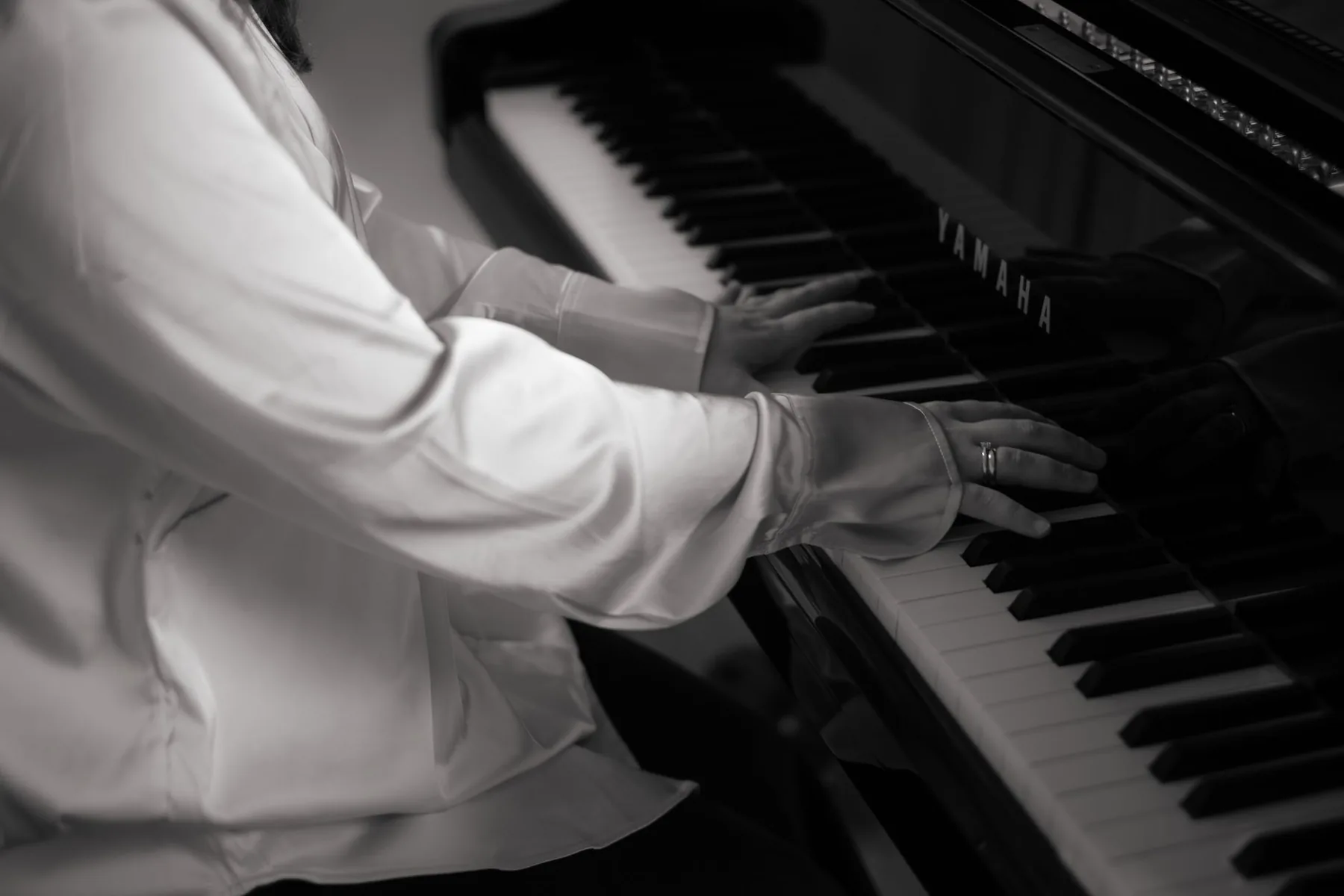 Musician playing a Yamaha piano Musician playing a Yamaha piano