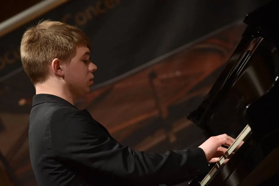 Young pianist performing on stage