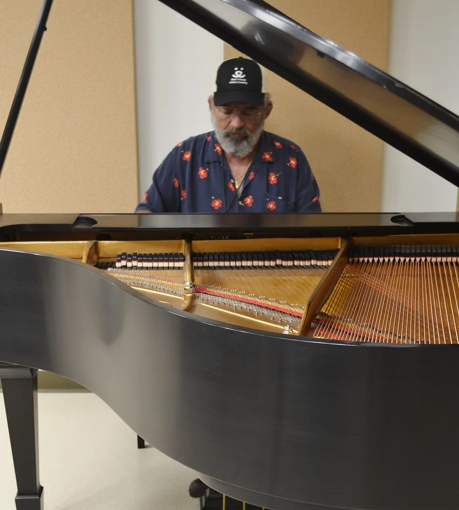 Musician playing a grand piano Musician playing a grand piano
